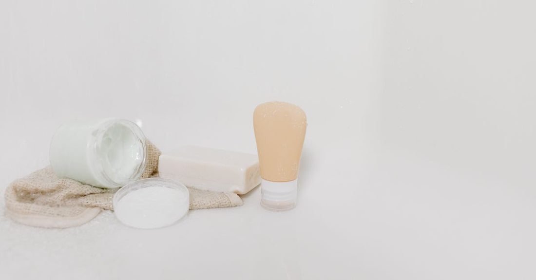 A flatlay of gentle exfoliating skincare products including a rice face mask and soft washcloths, illustrating how to exfoliate face without damaging skin.