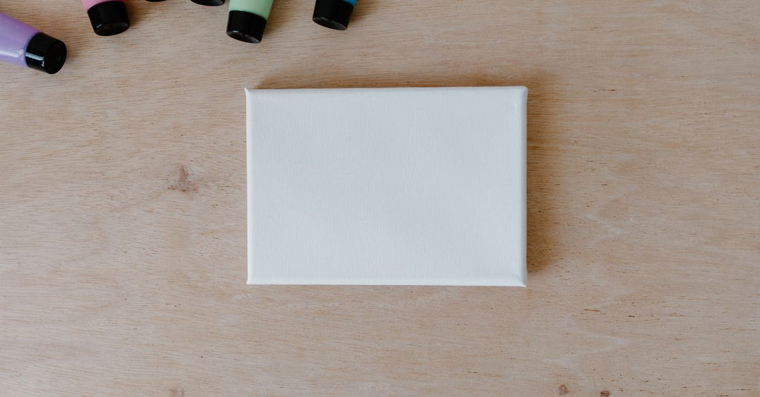 Flat lay of an acrylic nail kit with monomer, powder, brush and files on a white background, illustrating how to choose acrylic nail kits wisely.