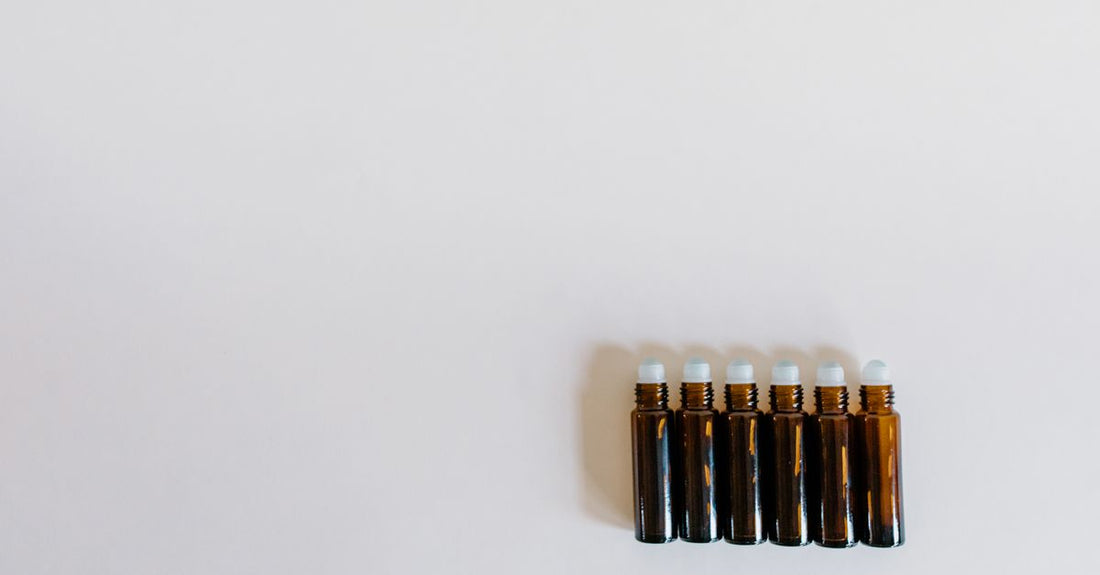 Assorted face oil bottles arranged on a light surface, illustrating an oils buying guide UK for selecting the right skincare formula
