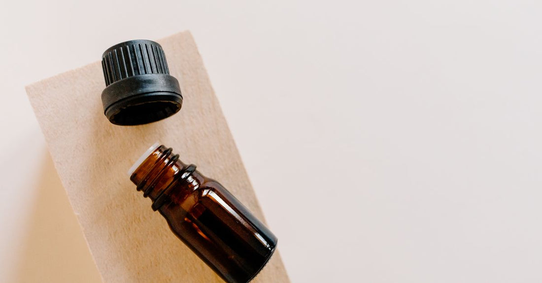 Natural hair growth oil bottle on white background illustrating how to stimulate hair growth naturally with plant-based ingredients.