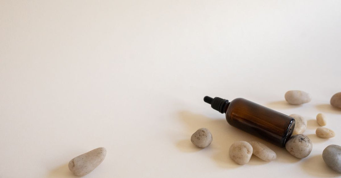 A selection of beard oil bottles with droppers on a wooden surface, illustrating how to choose beard oils.