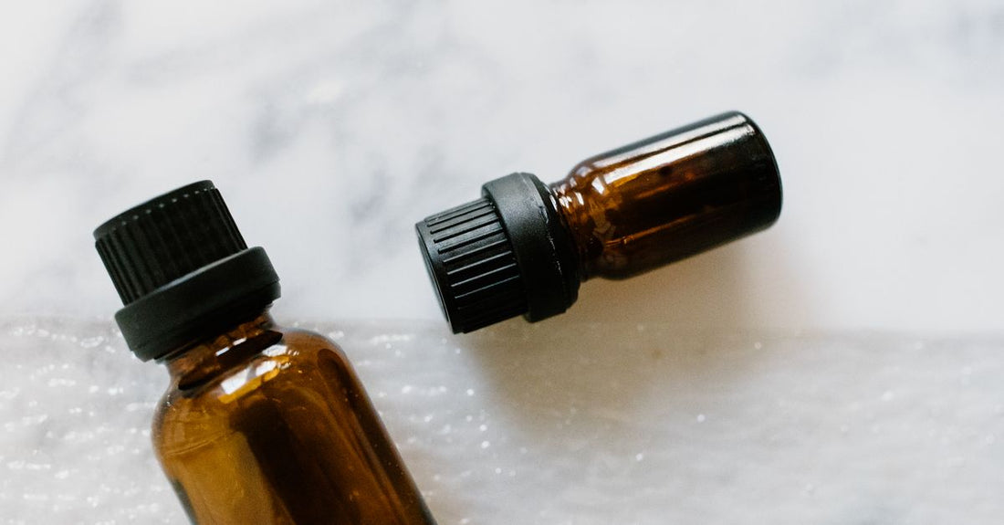 How to use face oil in skincare routine: glass bottle of face oil on white marble surface
