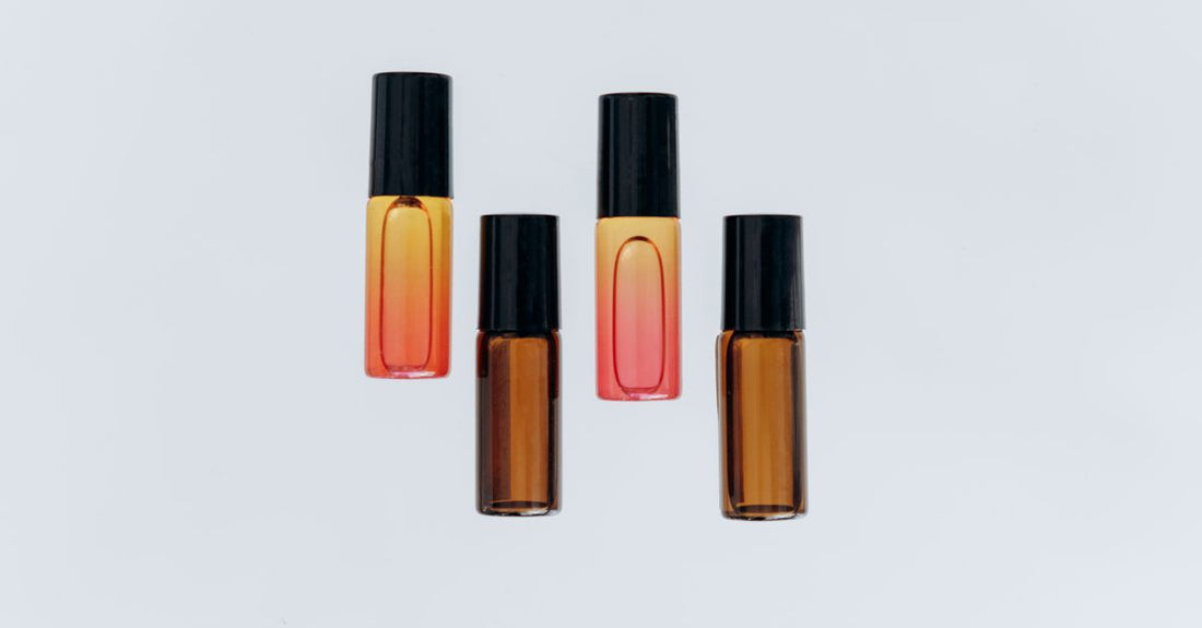 A selection of cuticle oil bottles on a light marble surface, illustrating how to choose cuticle oils for different nail needs.