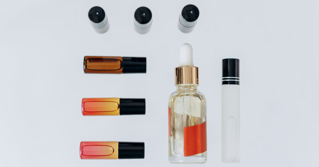 A selection of best long lasting perfume UK 2026 bottles arranged on a white marble surface with soft natural lighting.