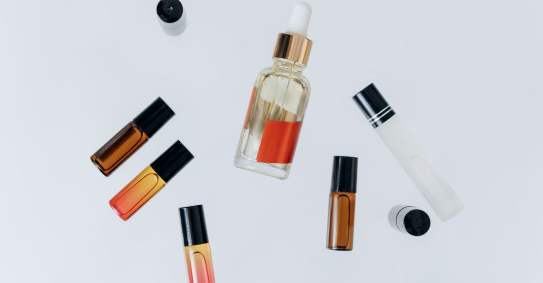 Collection of best perfume oil for long lasting UK bottles on a minimalist flatlay background