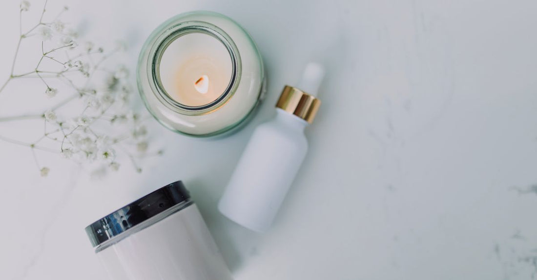 A row of tinted moisturiser bottles on a marble surface, illustrating how to choose tinted moisturisers UK for different skin types.