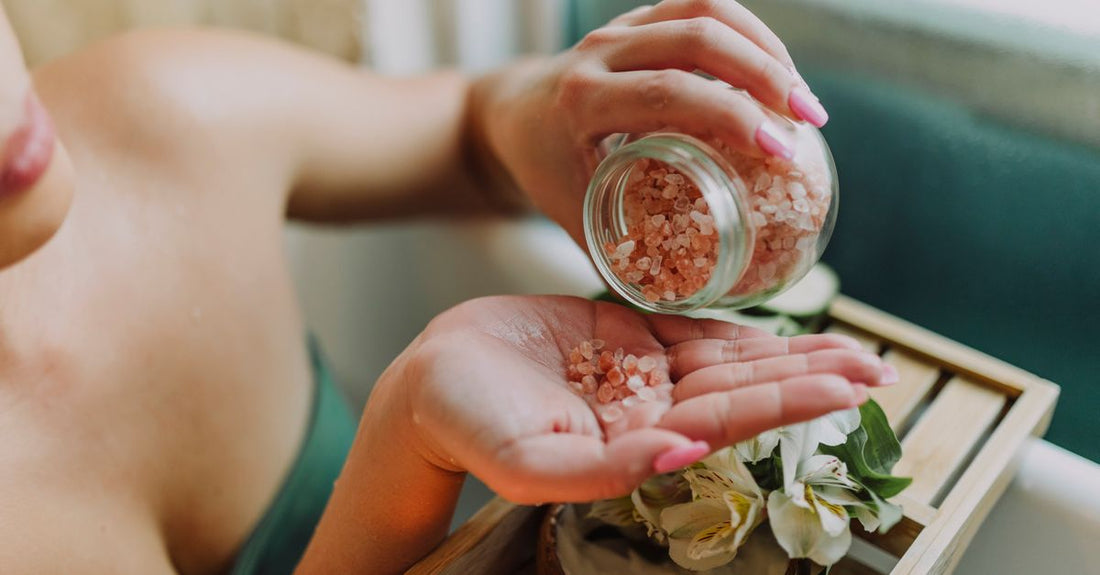 Best body scrub for ingrown hairs UK jar on a bathroom shelf, showing exfoliating texture.