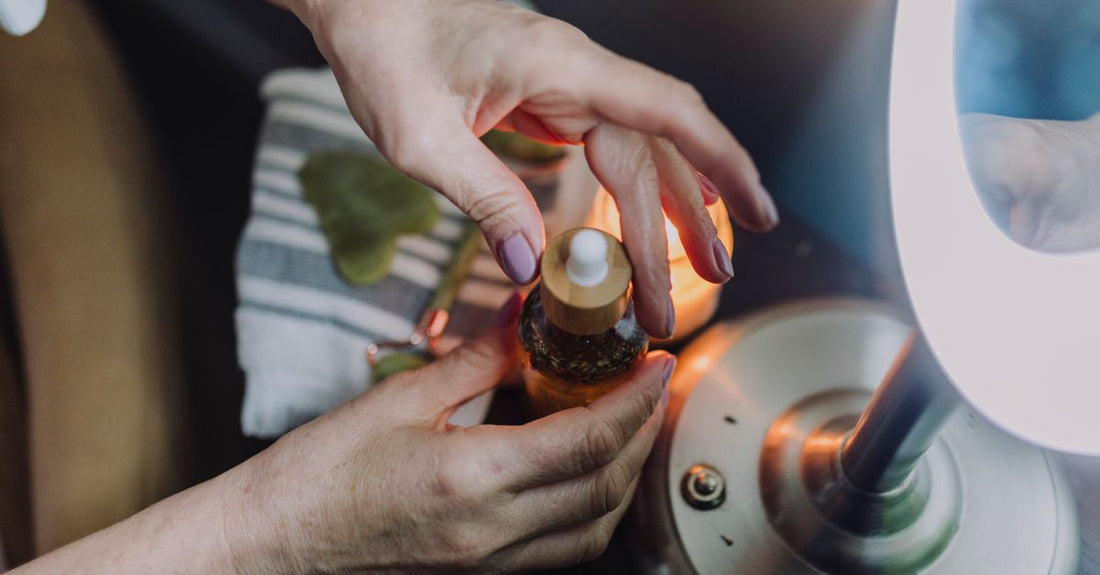 A glass bottle of face oil on a marble surface, illustrating how to choose face oil for long-term skin health.