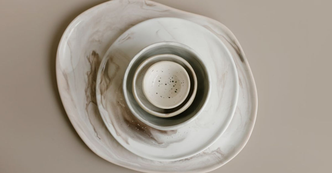 Three white moisturiser jars on a marble surface, representing the best creams 2026 for different skin types.