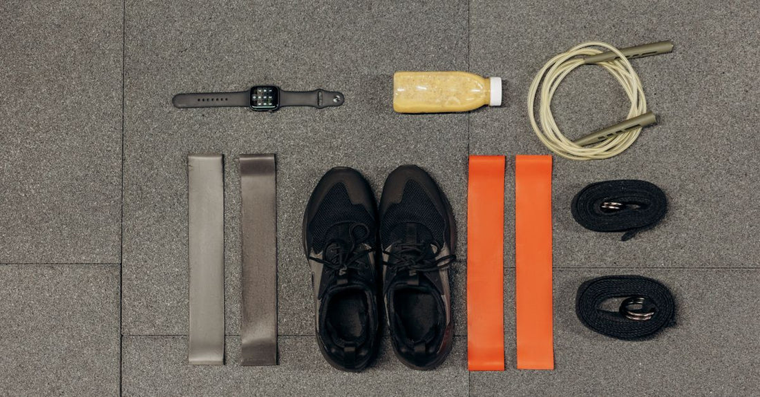 A flatlay of various hair elastics and ties including spiral, silk scrunchies and cotton ties on a light background, illustrating how to choose elastics & ties for damage-free hair.