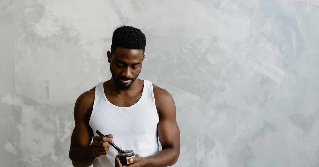 A selection of beard conditioners and oils arranged on a wooden surface, illustrating how to choose beard conditioners & oils for different beard types.