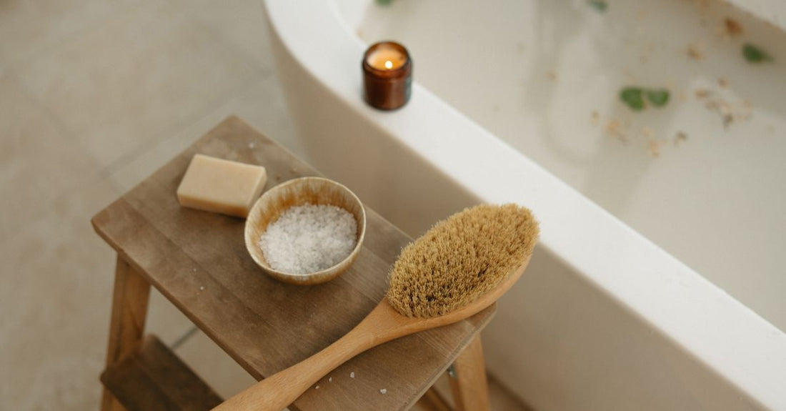 A natural bristle bath brush resting on a wooden bath caddy, best bath & body brushes 2026 review