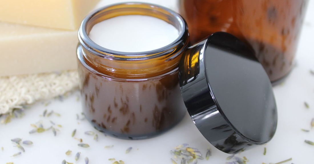 A jar of cleansing balm on a white background, showing the smooth balm texture inside.