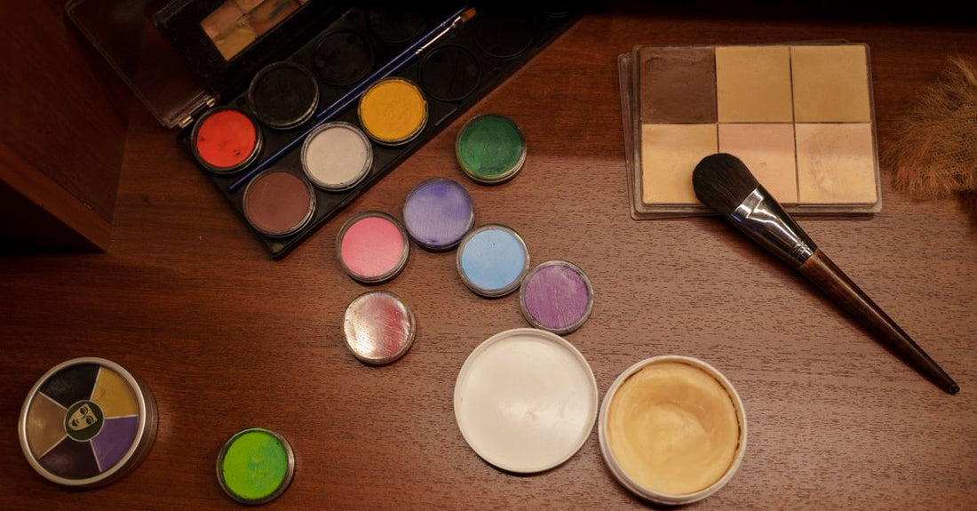A selection of best costume makeup 2026 palettes and products arranged on a white surface.