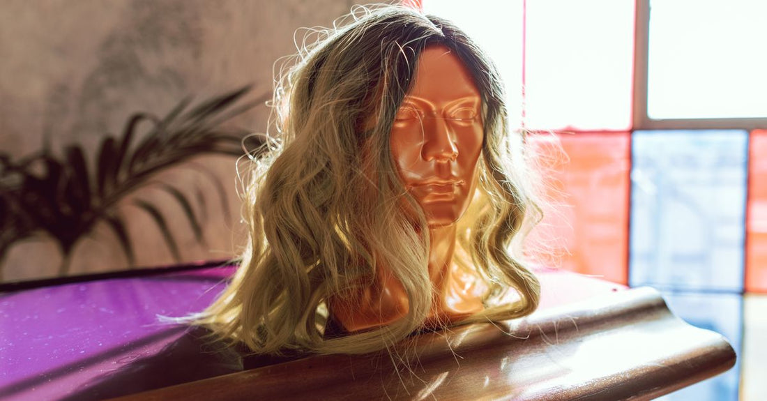 A high-quality synthetic wig displayed on a mannequin head, showcasing natural-looking waves and volume for best wigs UK 2026