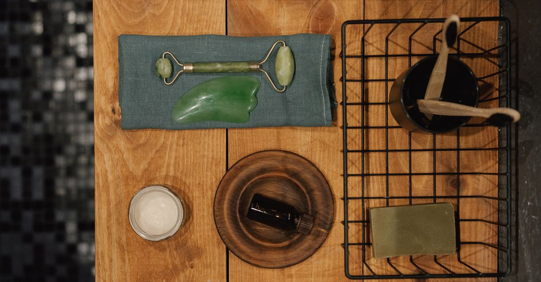 Selection of bath oil bottles on a marble surface, illustrating how to choose bath oils for different skin types.