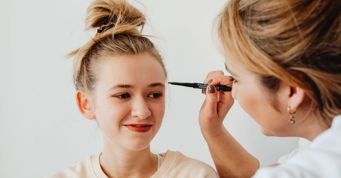 An array of eyebrow pencils and powders in various shades on a white background, illustrating the best eyebrow color 2026 options.