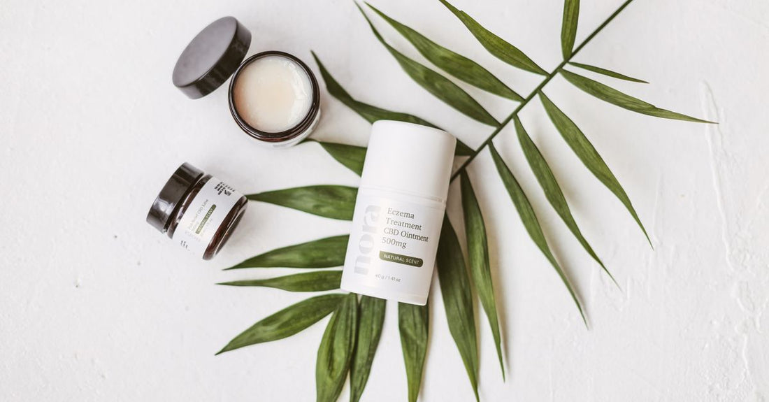 Three glass jars of rich skincare ointment on a marble surface, representing the best ointments UK 2026 for dry skin relief.