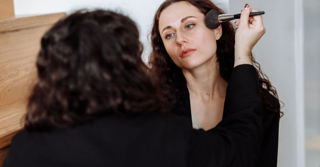 Root touch up powder with brush on a dressing table, showing how to cover grey roots quickly at home.