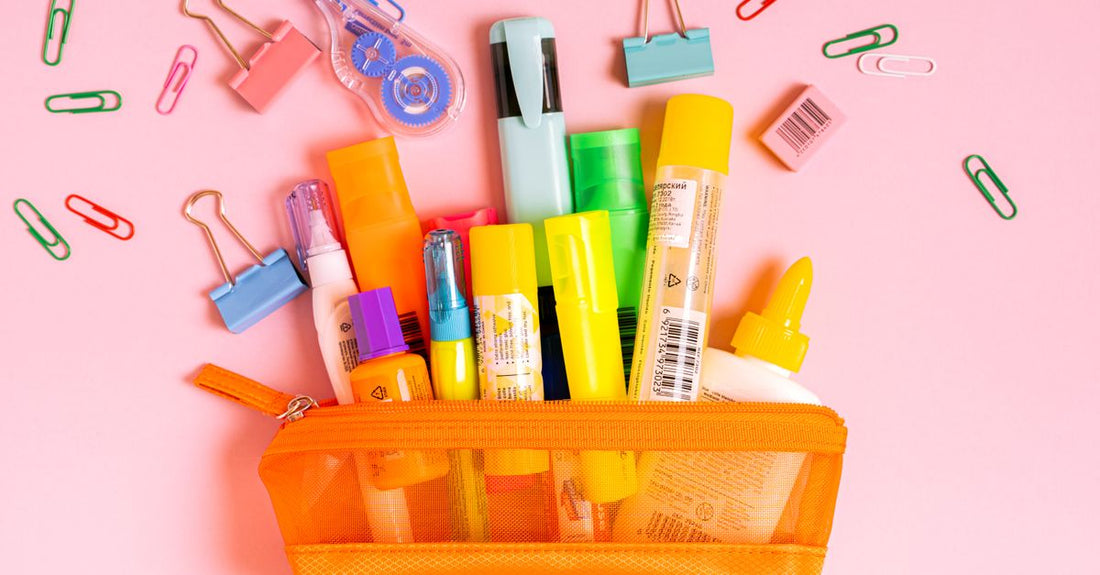 Assorted cosmetic bags in a flatlay arrangement with makeup brushes and skincare products, illustrating a cosmetic bags buying guide