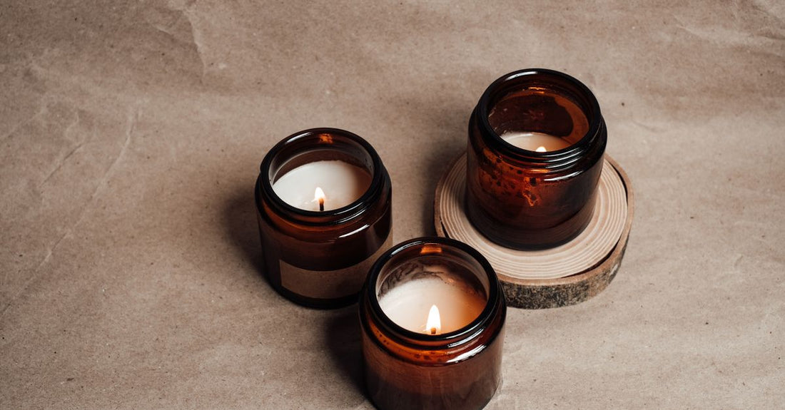 A selection of beard conditioner jars and tins arranged on a wooden surface, demonstrating how to choose beard conditioners for different beard types.