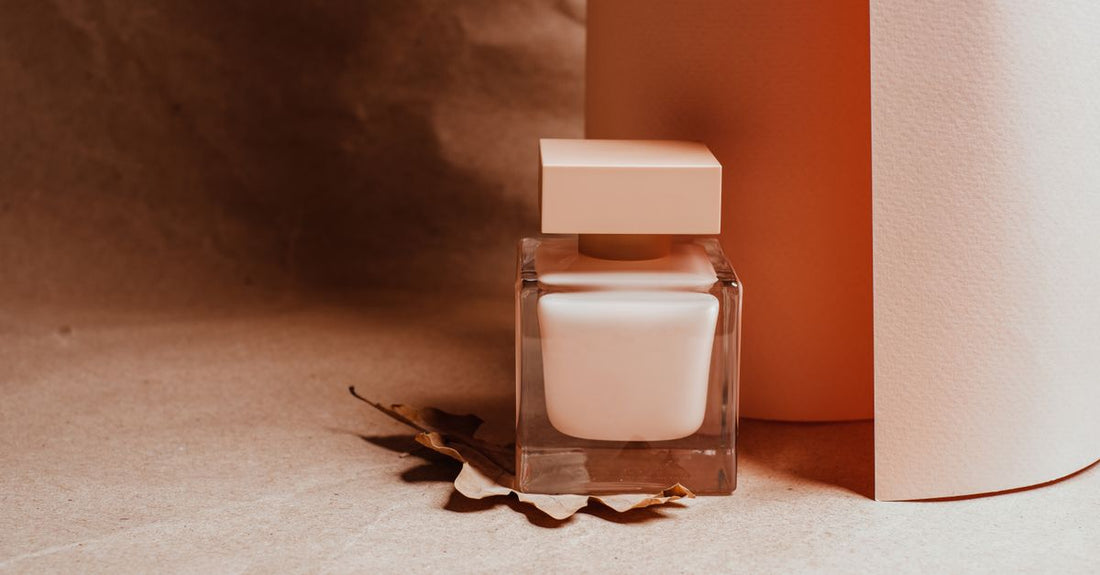 A flatlay of best cologne 2026 bottles in a row with minimalist packaging, highlighting their colour and shape.