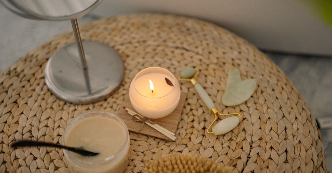A jar of creamy body scrub on a white marble surface, illustrating how to choose scrubs & body treatments UK.