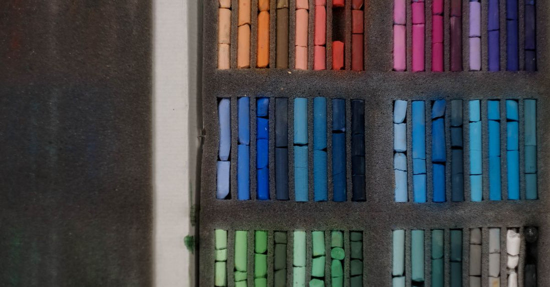 A selection of professional hair colour boxes and developer bottles arranged on a white shelf, illustrating a hair color buying guide for UK shoppers.