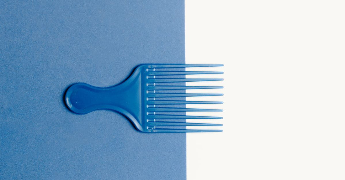 How to clean hair brushes properly: tools and a clean hairbrush on a bathroom shelf.