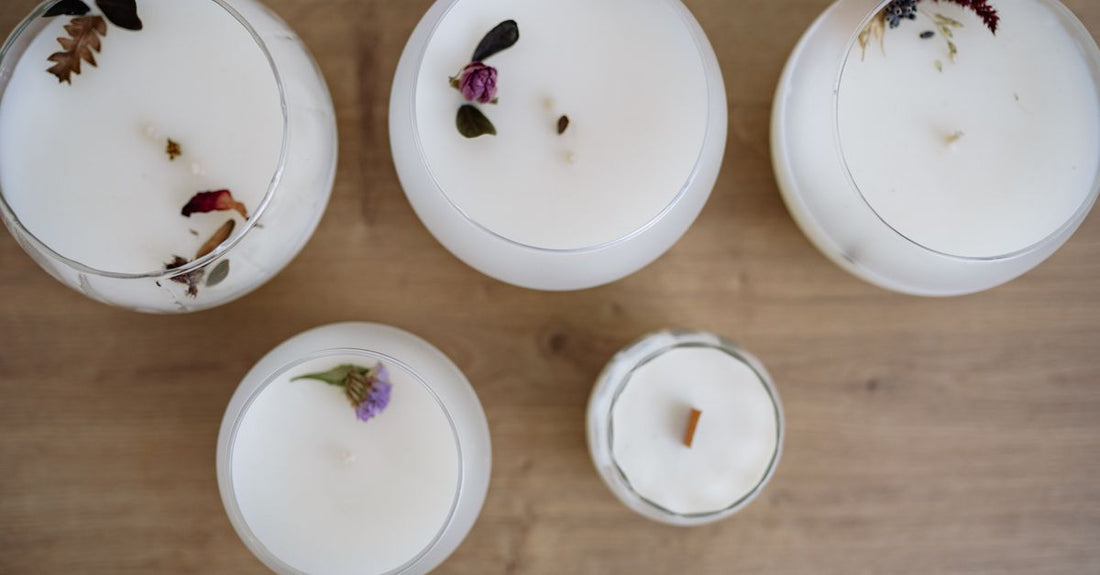 A sleek collection of eau de parfum bottles on a white marble surface, representing the best eau de parfum 2026 selection.