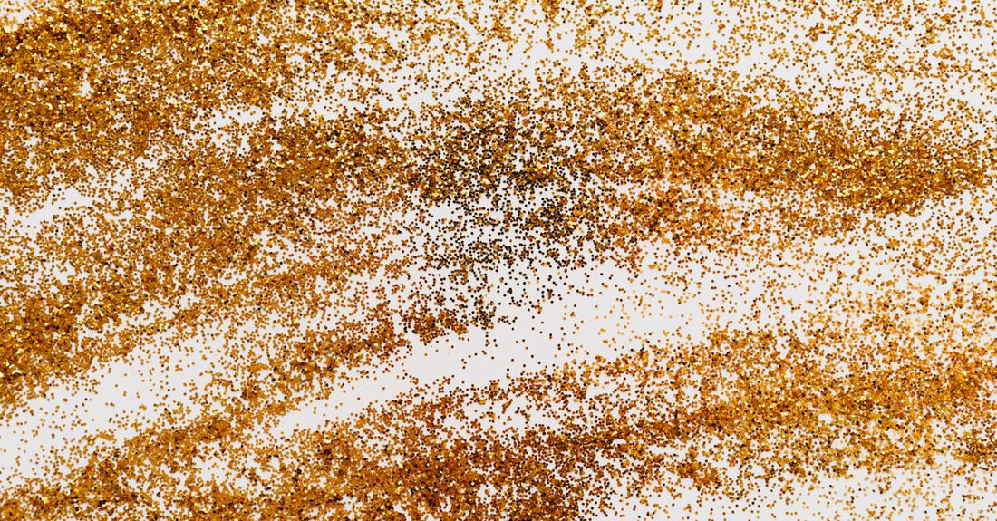 Assorted holographic nail glitter flakes in clear jars on a white background, showcasing the best glitters 2026 collection.