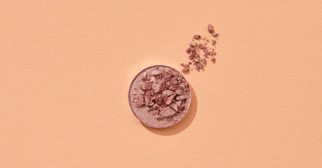 A flatlay of various makeup palettes with visible eyeshadow and blush pans, illustrating a makeup palettes buying guide UK.