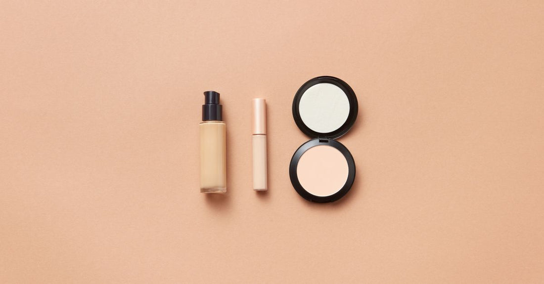 A selection of under eye concealers for mature skin on a marble surface, showcasing hydrating formulas.