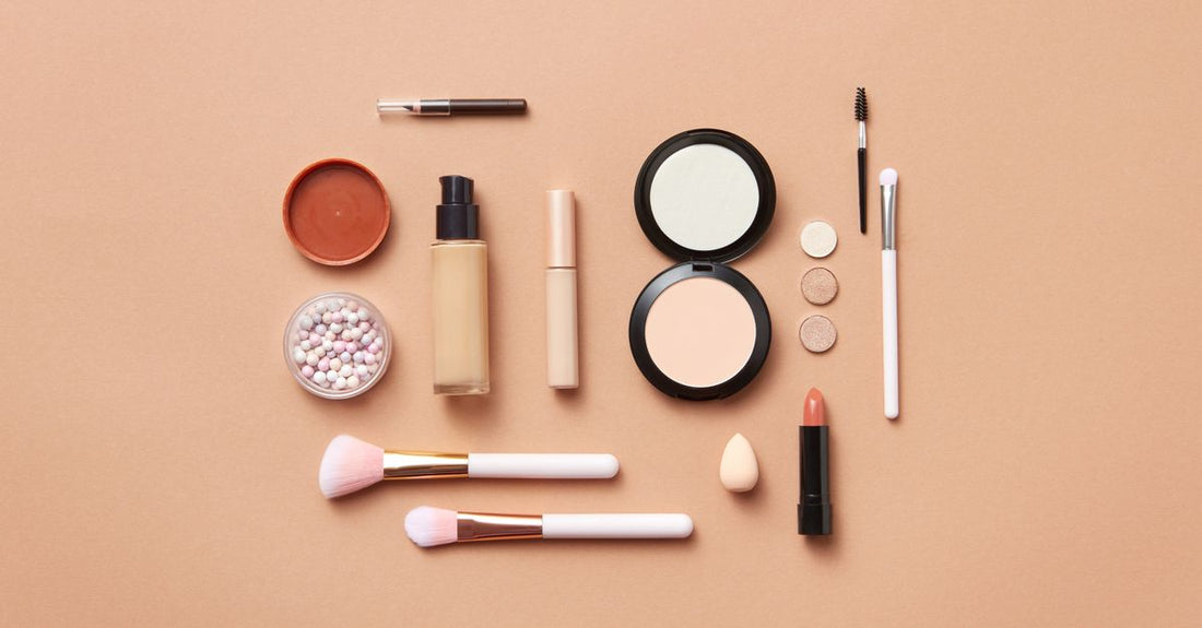A selection of the best concealer for dark circles UK products, including a colour-correcting palette and brightening pen, arranged on a marble surface.