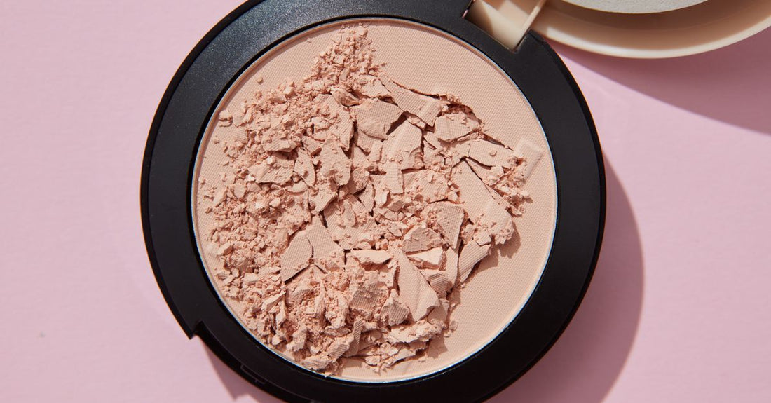 Translucent pressed powder compact open on a white surface, showing fine matte texture for how to use face powder for oily skin.