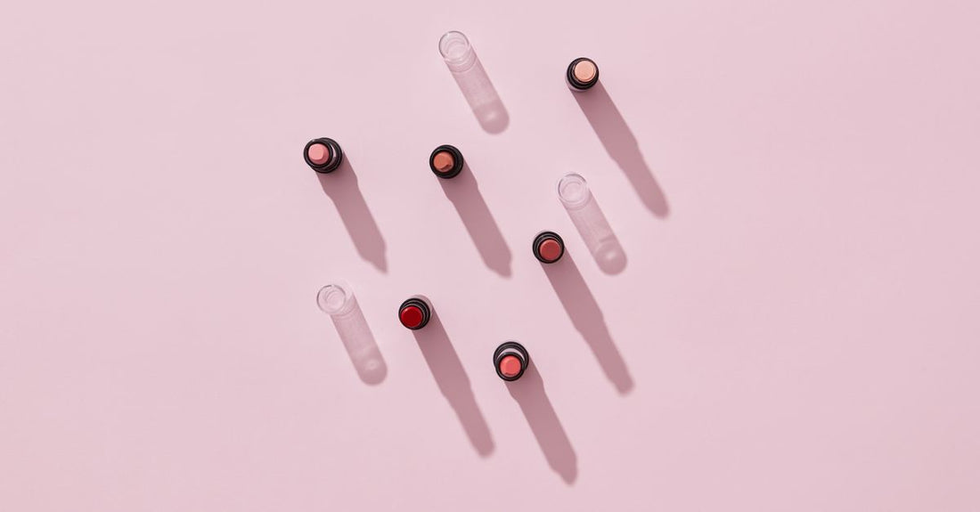 Selection of best lipstick UK 2026 tubes in a flatlay arrangement with swatches on white background.