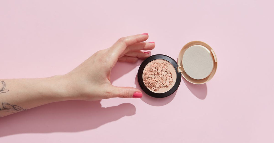 A selection of blush compacts in various shades arranged on a neutral flatlay surface, illustrating how to choose blush for your routine.