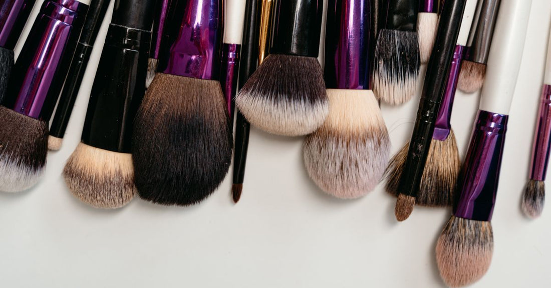 A flatlay of a synthetic makeup brush set with various brush heads on a clean white background, illustrating the best makeup brush set for beginners UK.