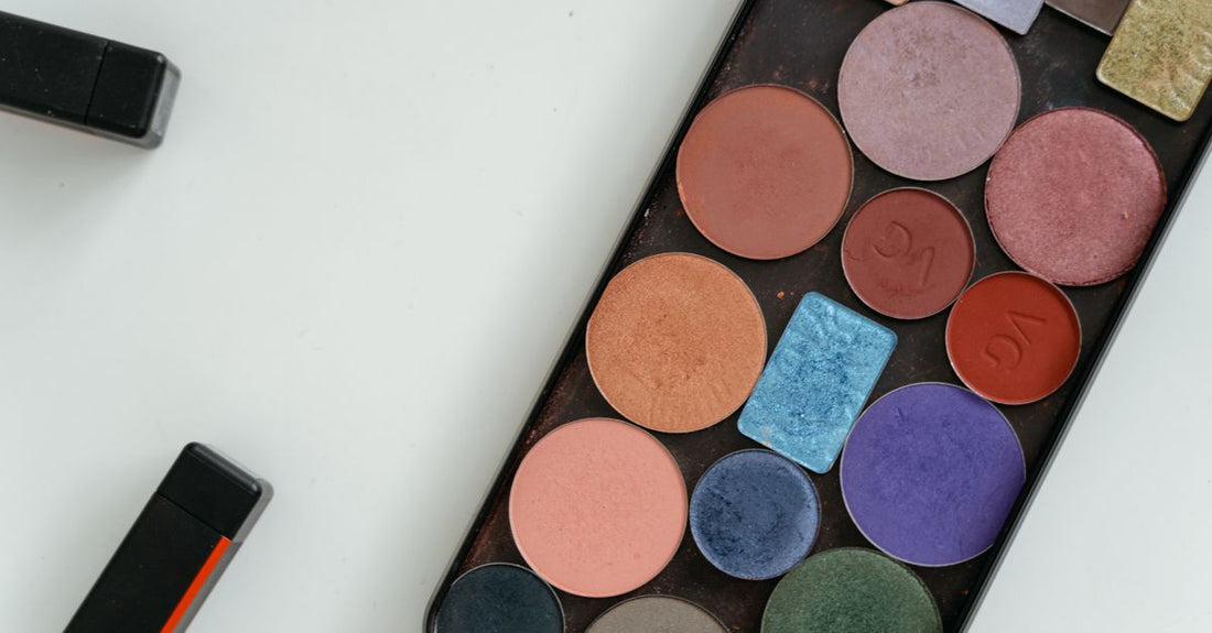 An eyeshadow palette with warm copper and plum shades, ideal as the best eyeshadow palette for brown eyes, displayed on a white background.