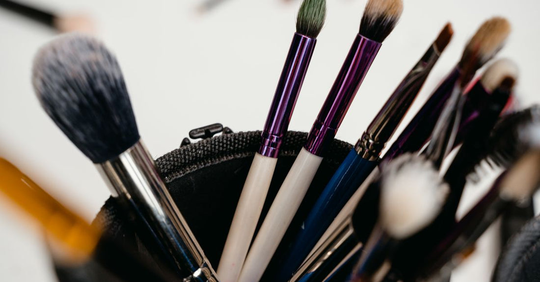 A close-up of a fluffy eyeshadow blending brush on a white background, demonstrating how to use eyeshadow brush for blending.
