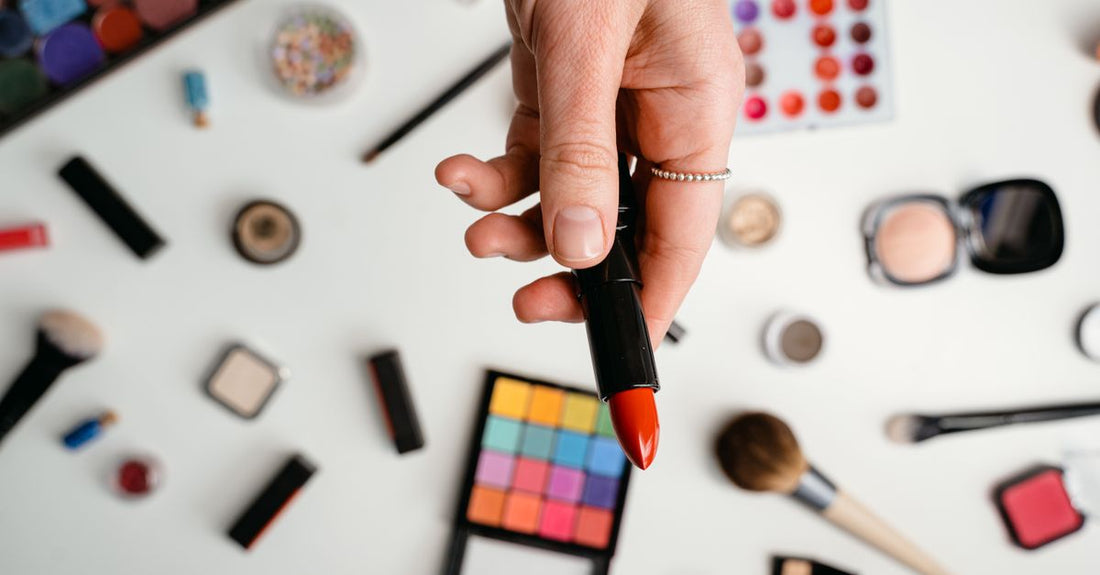 A clean flatlay of eyeshadow primer tubes and pots on a white marble surface, representing the best eyeshadow bases and primers available in the UK for 2026.