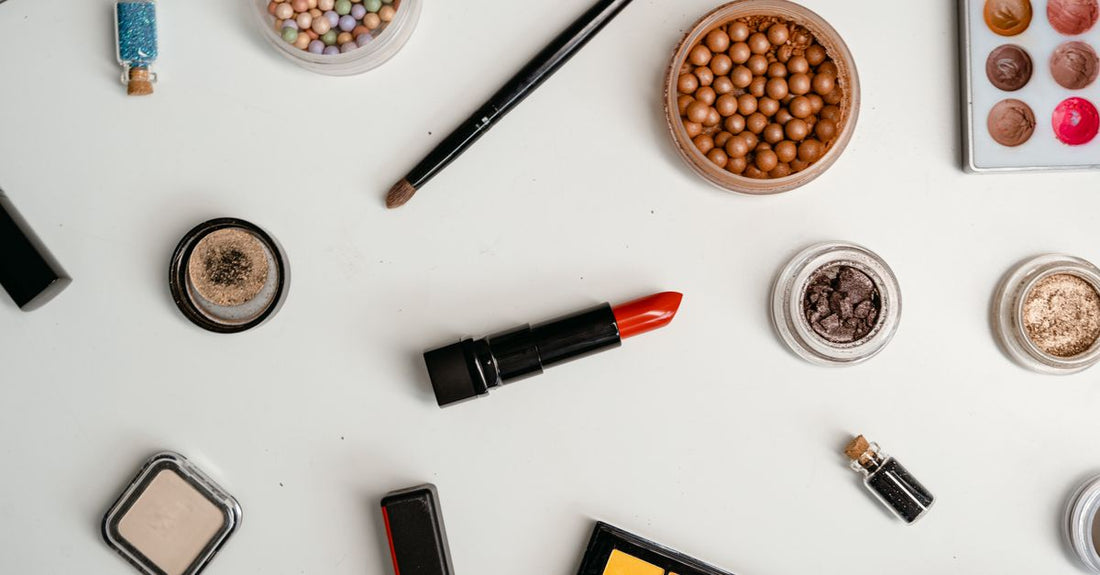 A flatlay of neatly arranged skincare bottles and jars representing different product categories for a complete morning-to-night routine.