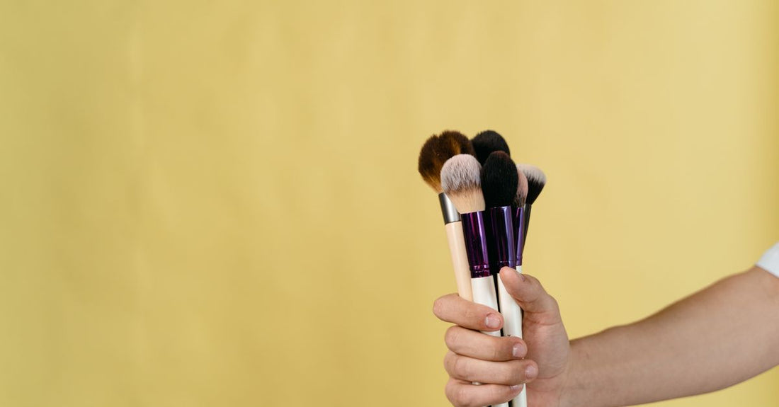 Makeup brushes being cleaned with a gentle foaming cleanser, showing how to clean makeup brushes effectively.