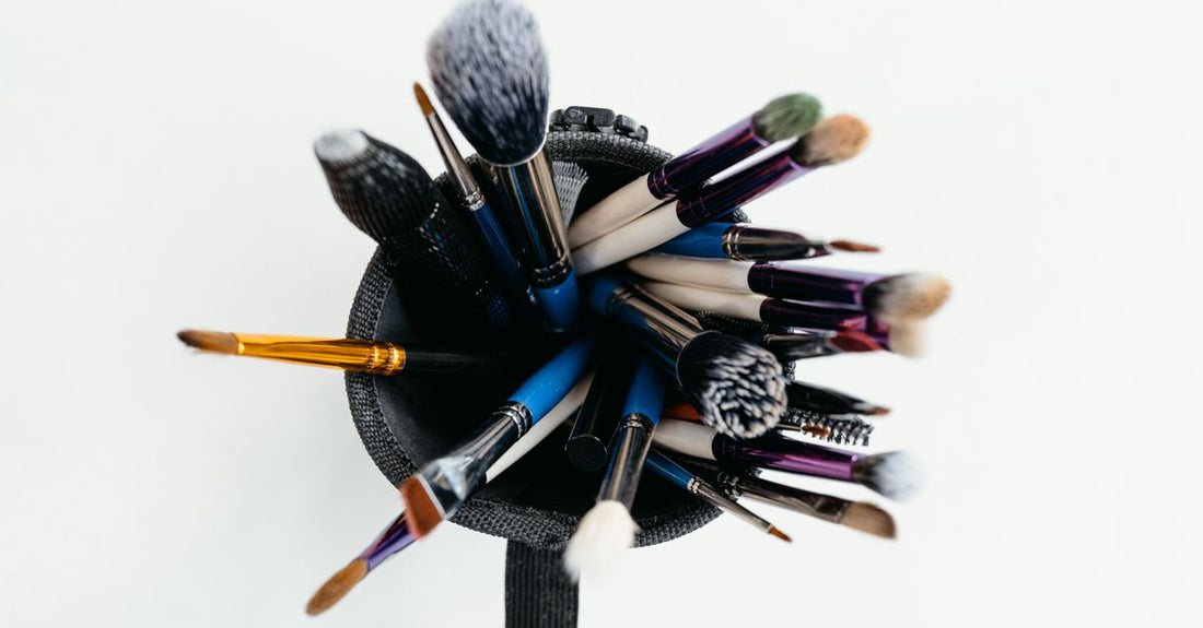A flatlay of various high-quality hair brushes including paddle, round, and vented styles, representing the best hair brushes UK 2026.