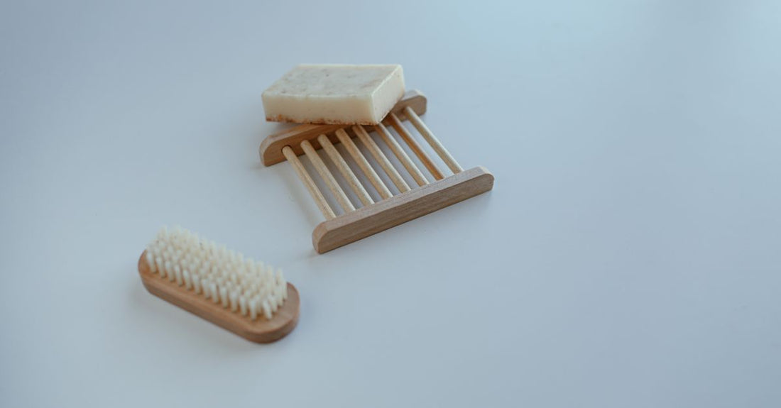 Wooden lint remover brush with black boar bristles on a neutral background, representing the best lint removers 2026.