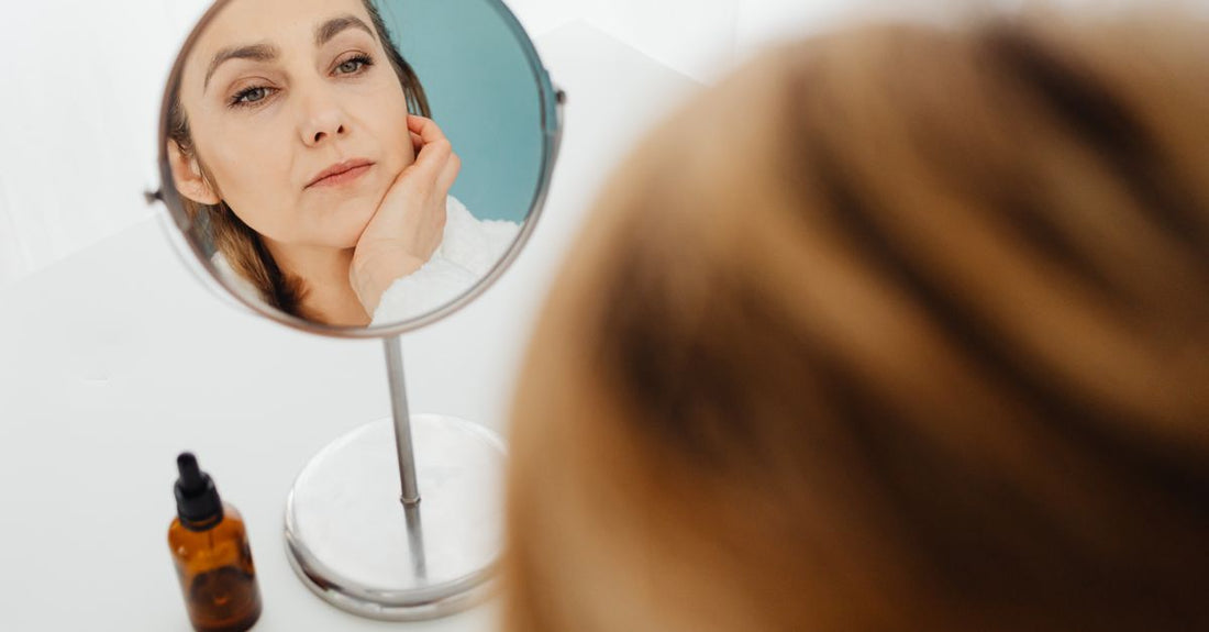 A collection of anti-ageing skincare products on a marble surface, representing a routine for 30s.