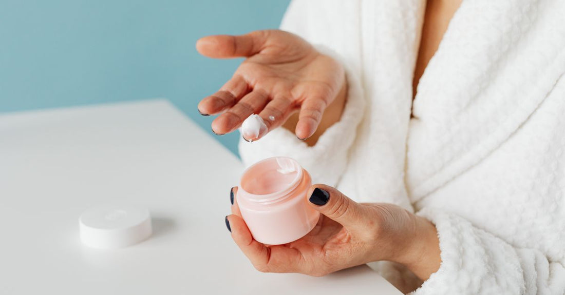 A sleek jar of best night cream for anti-aging resting on a cool marble surface, symbolising luxury skincare.