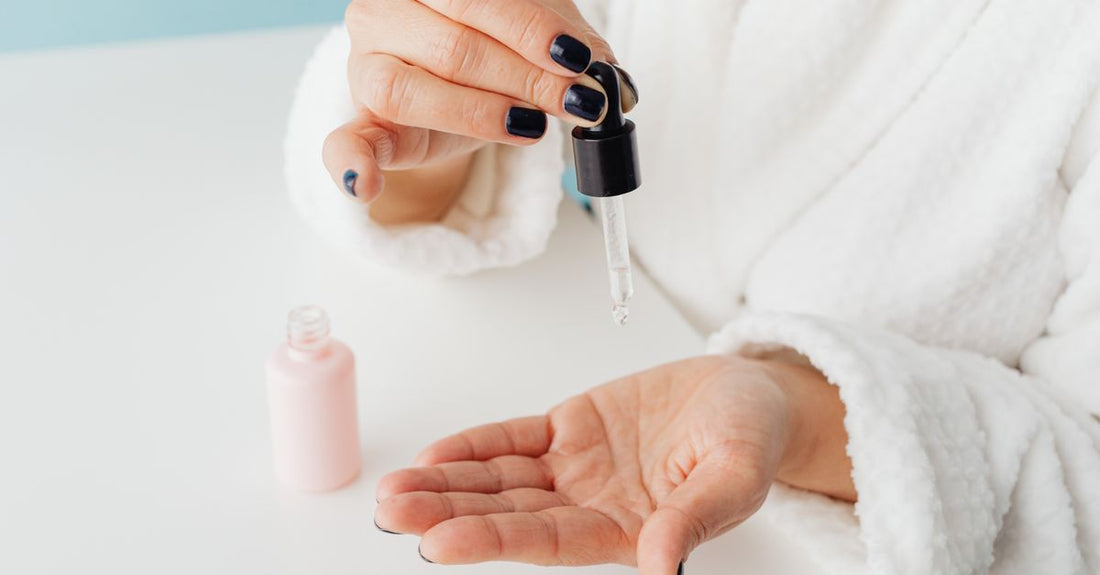 A skincare serum bottle on a marble surface, representing the best face 2026 essentials for a mistake-free routine.
