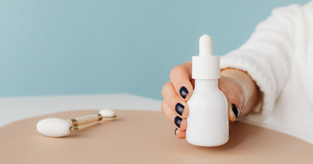 Assorted facial self tanner bottles and drops on a light background, illustrating how to choose facial self tanners UK