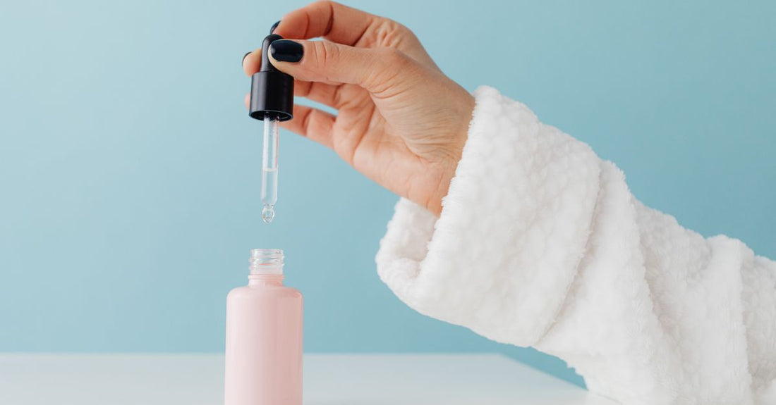 A bottle of best facial self tanner for pale skin UK on a light background, with dropper dispenser.